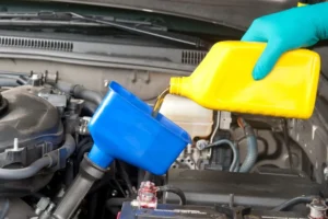 All German Auto change oil; image of oil being poured on a funnel
