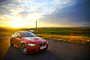 All German Auto BMW in Escondido, CA. An image of a BMW on the road with a sunrise in the background.
