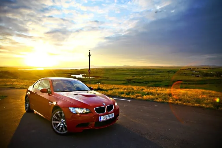 All German Auto BMW in Escondido, CA. An image of a BMW on the road with a sunrise in the background.
