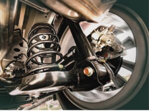 All German Auto steering and suspension repair in Escondido. Image of a car’s steering and suspension system viewed from below.