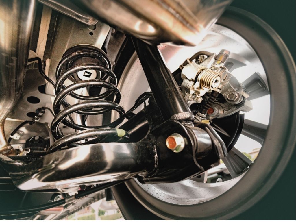 All German Auto steering and suspension repair in Escondido. Image of a car’s steering and suspension system viewed from below.