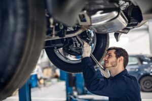 Auto car repair service center examining car suspension