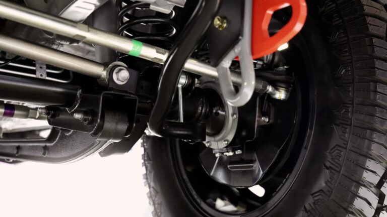 Close up of a rear car suspension and exhaust